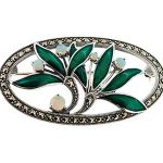 Front view of a sterling silver brooch featuring green enamel leaves, real opal berry accents, and a marcasite‑studded oval surround, displayed on a white background