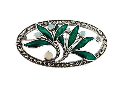 Front view of a sterling silver brooch featuring green enamel leaves, real opal berry accents, and a marcasite‑studded oval surround, displayed on a white background