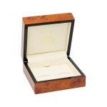 A beautiful, veneered wooden gift box pictured open.