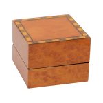 A beautiful, veneered wooden gift box pictured closed.