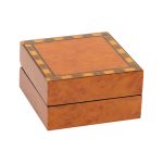 A beautiful, veneered wooden gift box pictured closed.