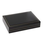 Black leatherette box with a black pad base and a white silk inner lid. Pictured closed.