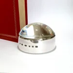 Close-up of sterling silver surround with feature British hallmark, highlighting artisan detail and official authenticity. Pictured next to a red book.