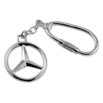 Sterling silver Mercedes keyring fob photographed on a plain white background, showcasing its polished finish and iconic badge design.