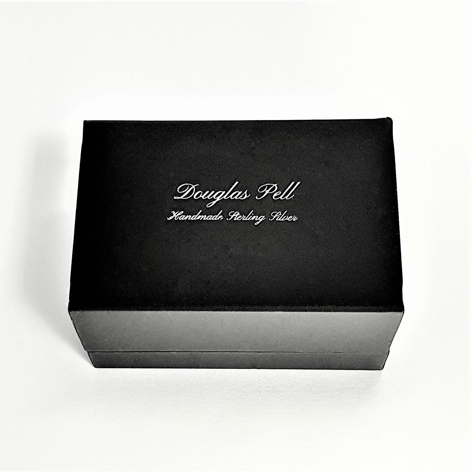  Douglas Pell's luxurious gift box for cufflinks closed, showing the Douglas Pell logo on the top.