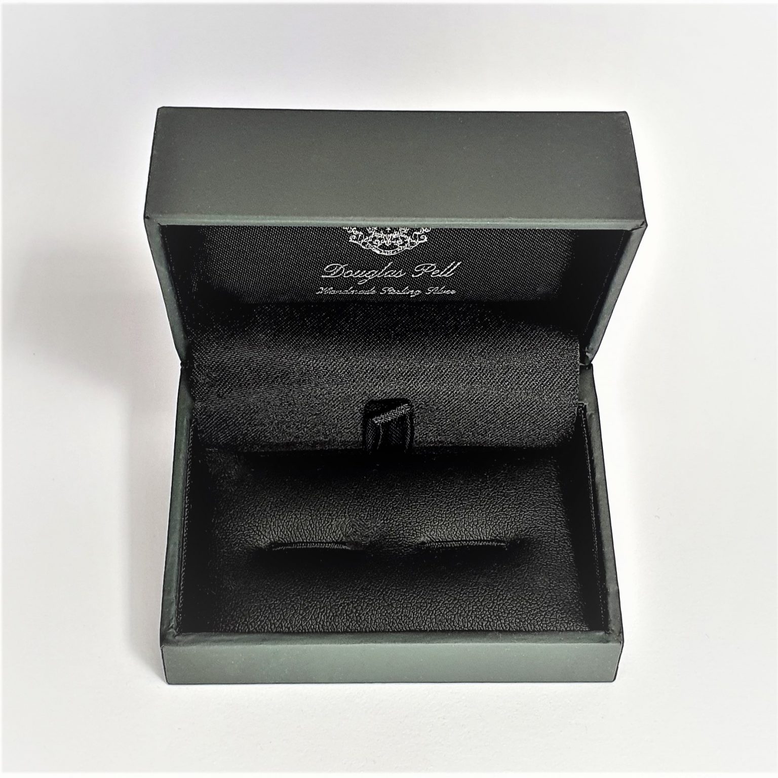 Douglas Pell's luxurious gift box for cufflinks is open and has the Douglas Pell logo on the top and inside of the lid.