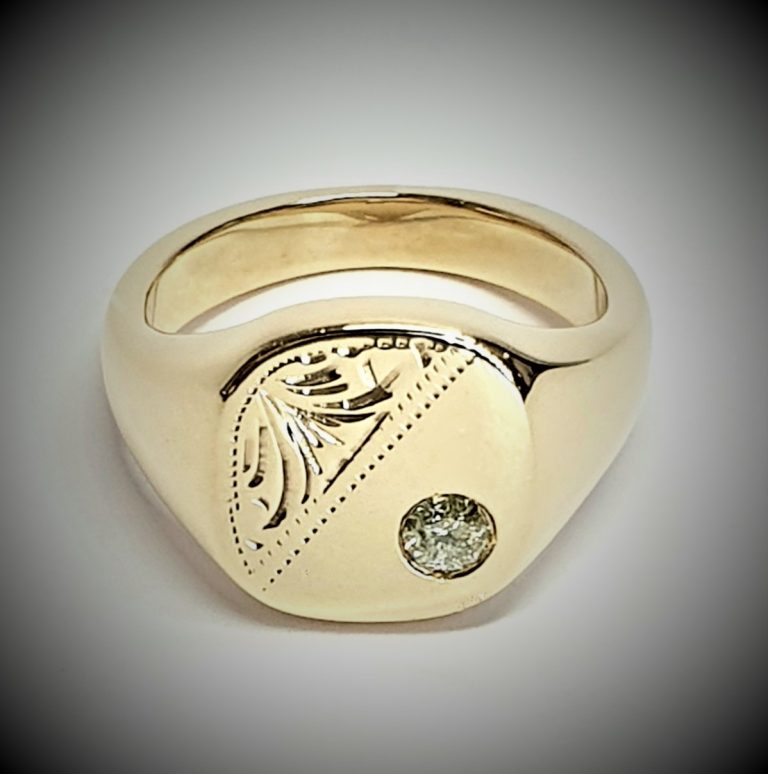 9ct Gold Cushion shaped Heavy signet ring with a Scroll pattern engraved in one corner and a single champagne colour Diamond in the other corner.