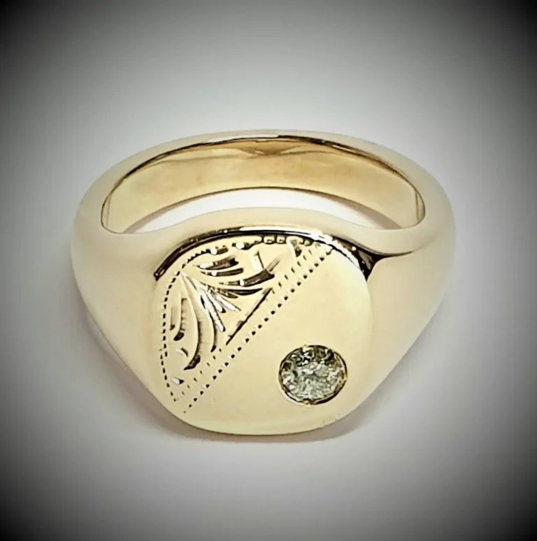 9ct Gold Cushion shaped Heavy signet ring with a Scroll pattern engraved in one corner and a single champagne colour Diamond in the other corner.