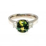 Ring laying down with a clear view of the sapphire and platinum setting.