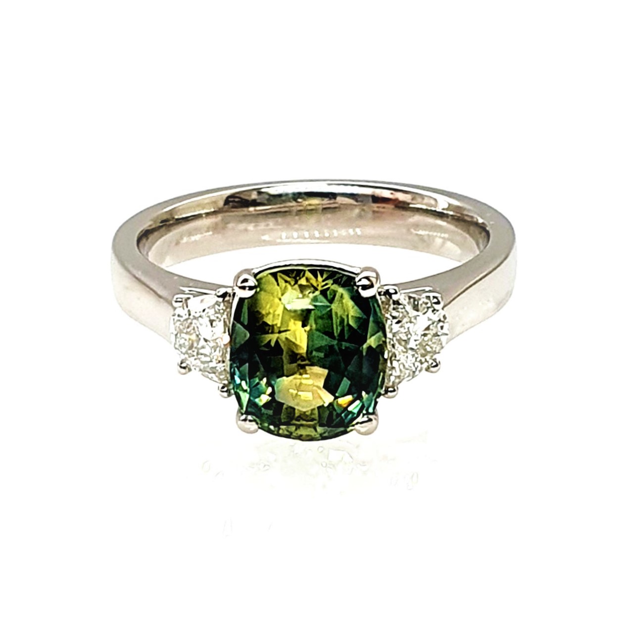 Ring laying down with a clear view of the sapphire and platinum setting.