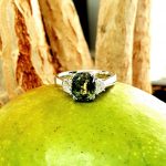 Ring resting on an apple with warm contrast enhancing the sapphire’s vivid colour.
