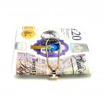 Gold clip for your cash with melted gold ,bar design displayed with a twenty pound note