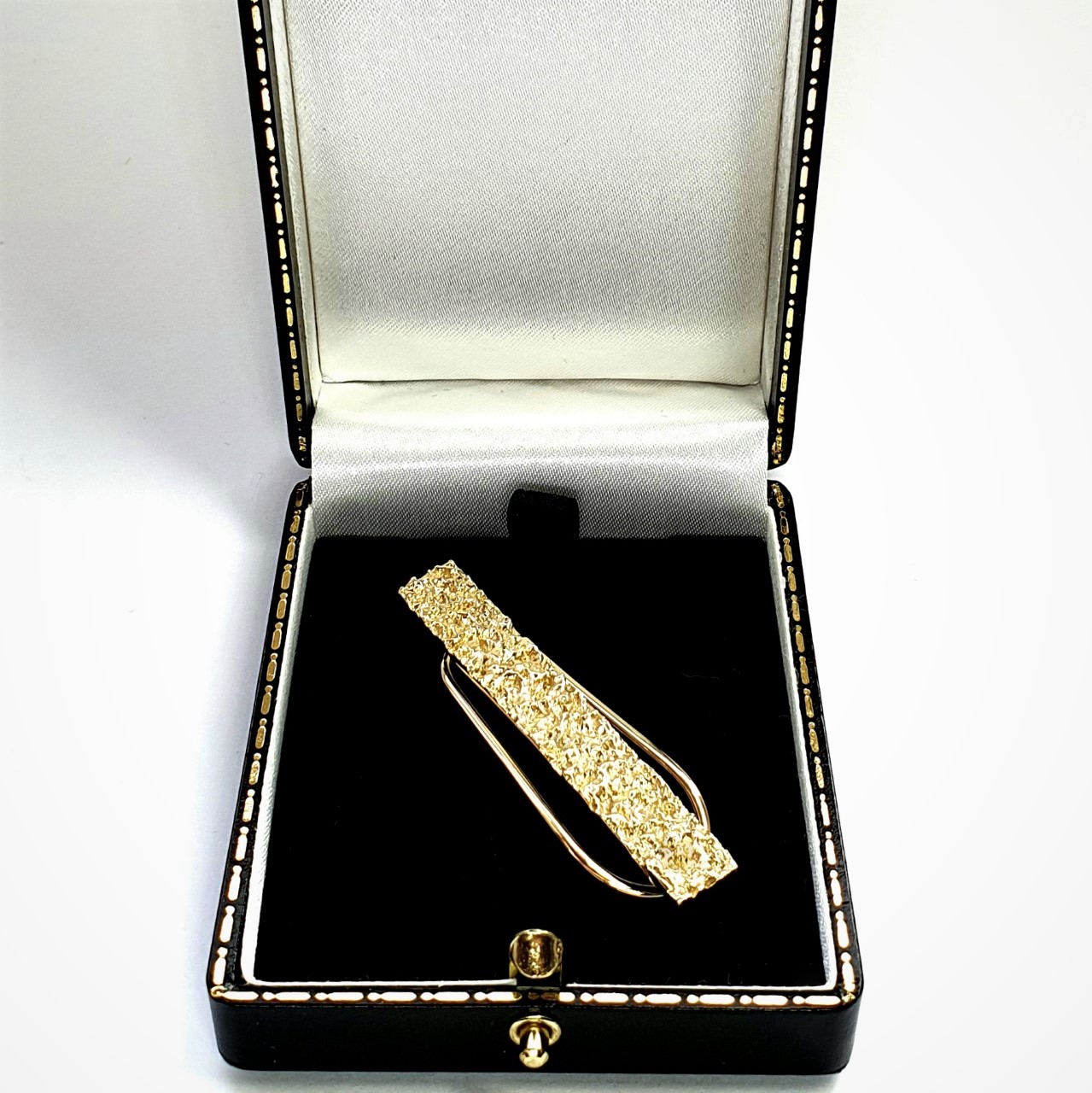 Melted gold bar effect for your cash, pictured at right angle sitting in a black jewellery box.