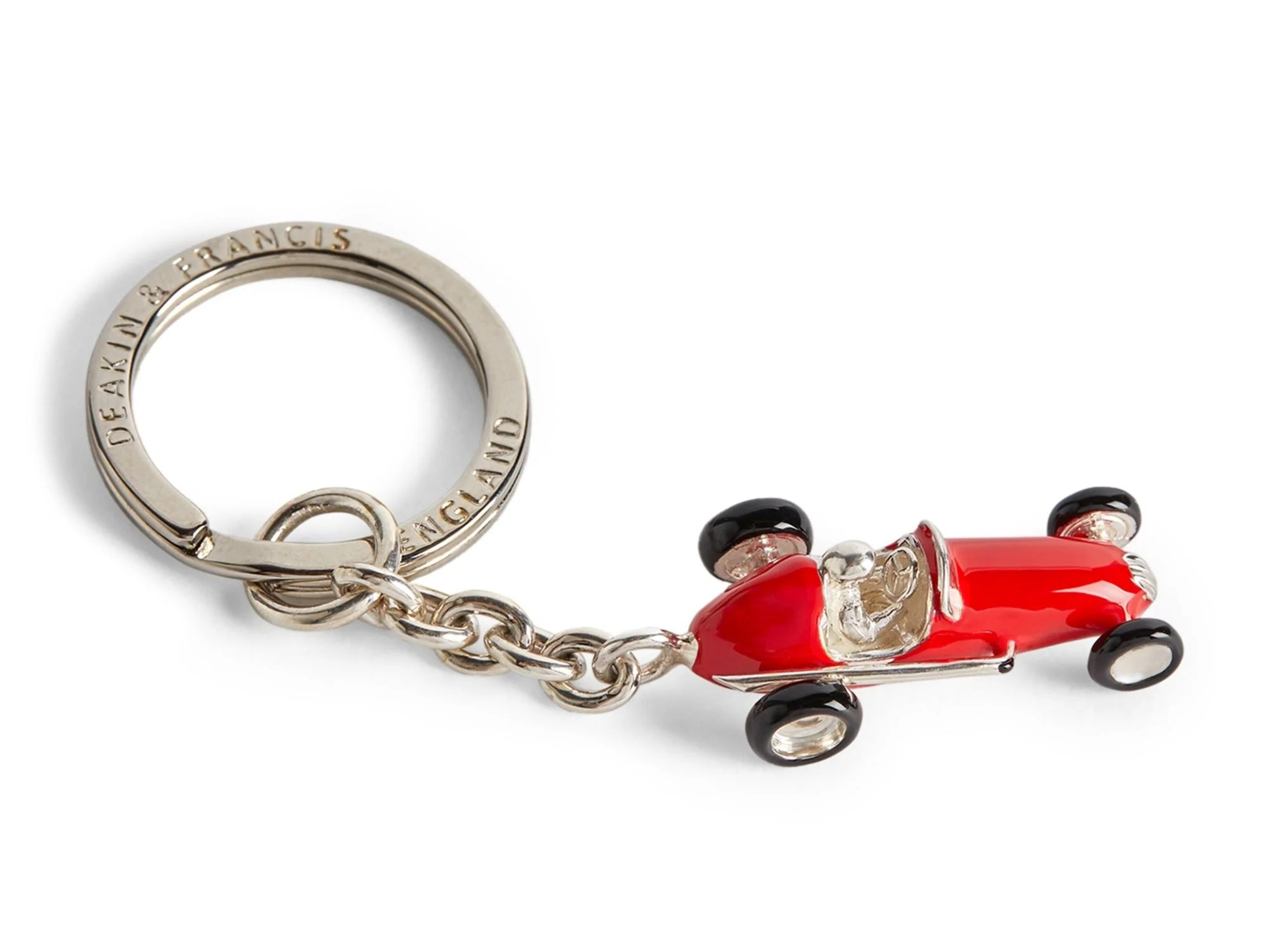 Close-up of red enamel racing car keyring crafted in sterling silver, featuring black enamel tyres and high-gloss finish.