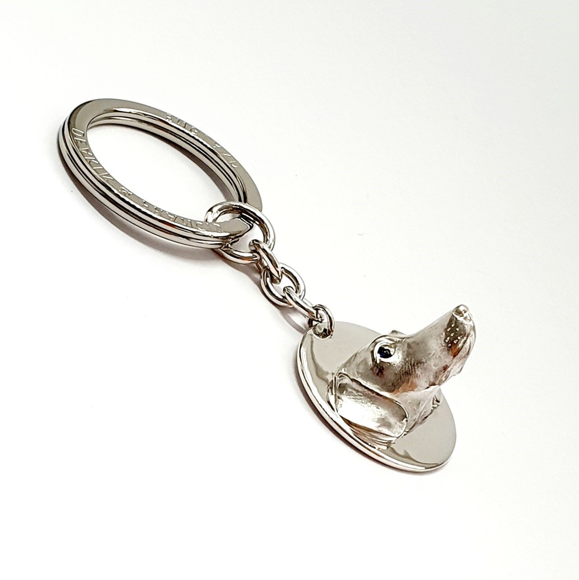 Genuine 925 silver key ring with the face of a Dachshund dog with blue sapphire eyes.