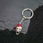 Gift-Ready Luxury: A sterling silver skull keyring with a red bandana and popping red eyes, crafted in the UK and presented in a stylish gift box—perfect for collectors and trendsetters alike.