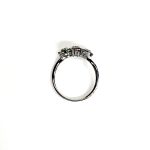 A captivating image of a Three Cluster Emerald Ring in 18ct white gold. The ring showcases three clusters of vibrant green emeralds, with six emeralds in each cluster. Adorning the ring shank is a graceful wave design, adding a touch of elegance to the overall aesthetic. The clusters are accentuated by three sparkling diamonds, positioned at the centre of each cluster." Side view.