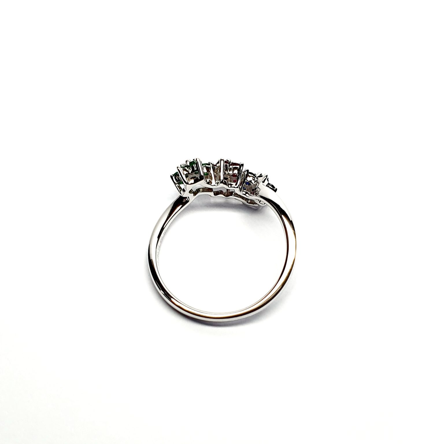 "18ct White Gold Sapphire, Ruby, Emerald & Diamond Three-Cluster Ring: Mesmerizing beauty with vibrant gemstones, exquisite craftsmanship, elegant crossover wave shank, and unmatched quality."