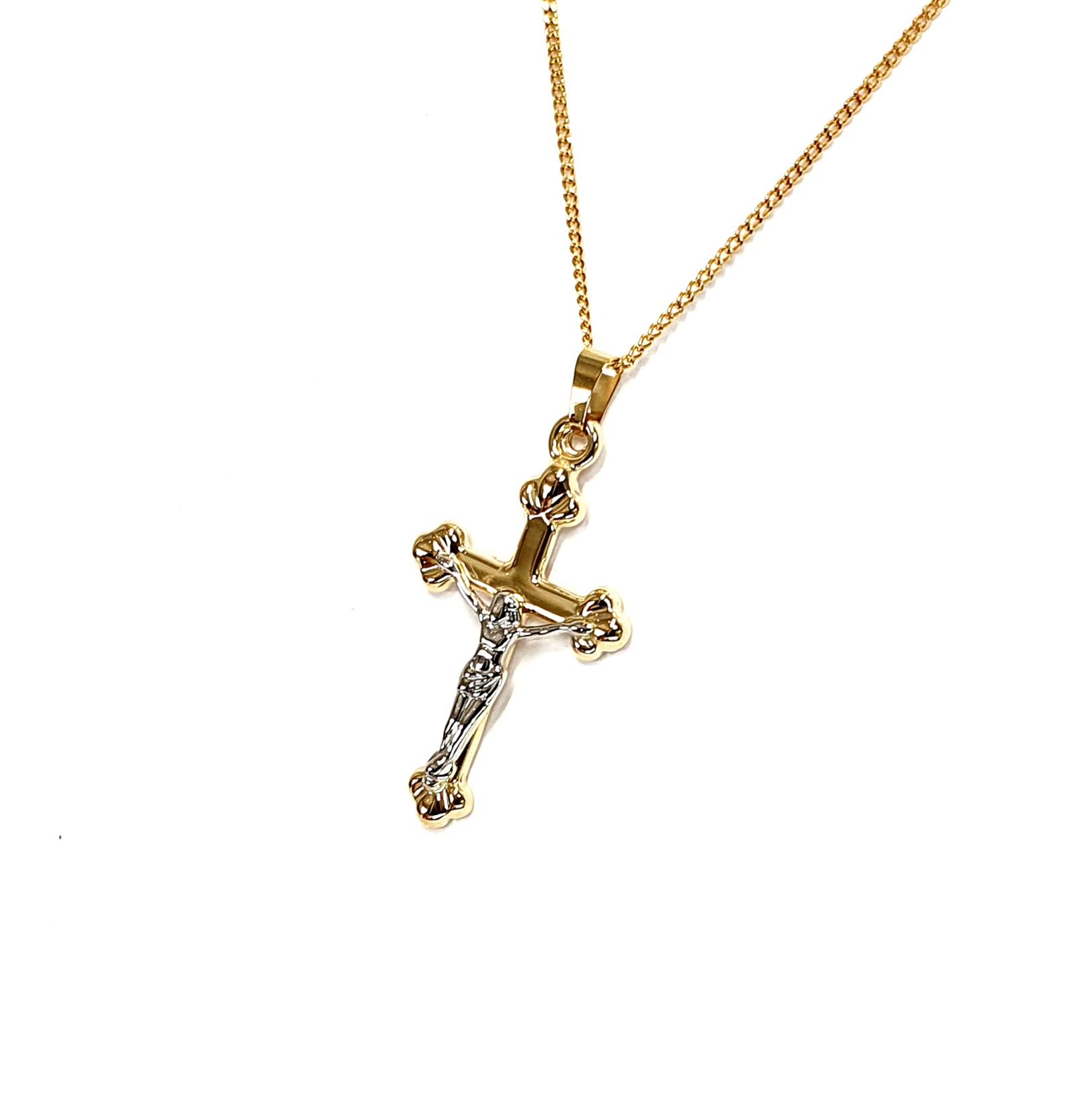 The Staveley 9ct Crucifix Necklace is 32mm with the top saddle loop 25mm x 16.8mm without and is 2mm in depth. It is made with a hollow 9ct yellow gold tube with a white gold Jesus, all highly polished. It can be purchased independently or with a 16, 18 or 20-inch traditional solid gold curb link chain.