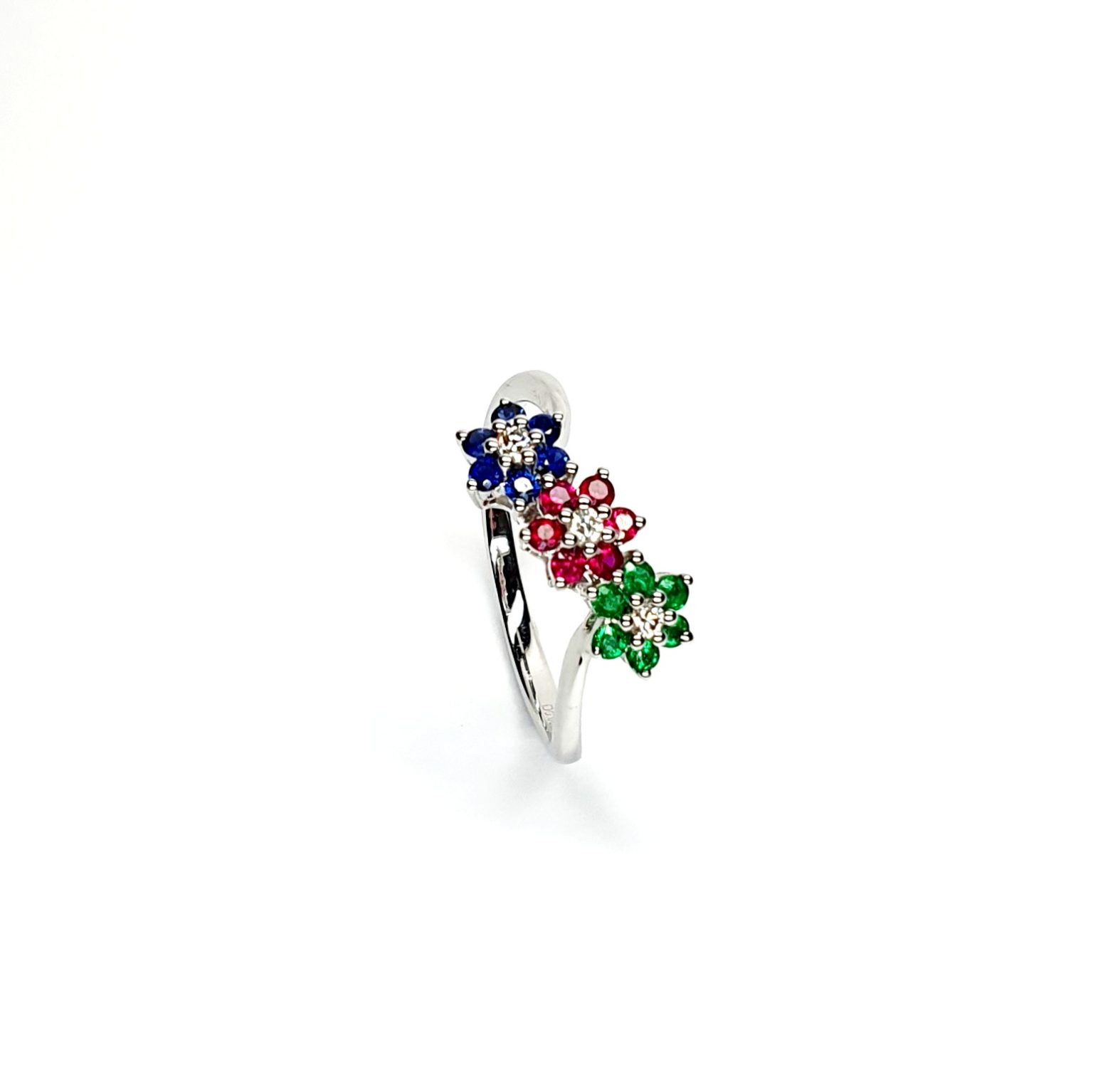 "18ct White Gold Sapphire, Ruby, Emerald & Diamond Three-Cluster Ring: Mesmerizing beauty with vibrant gemstones, exquisite craftsmanship, elegant crossover wave shank, and unmatched quality."