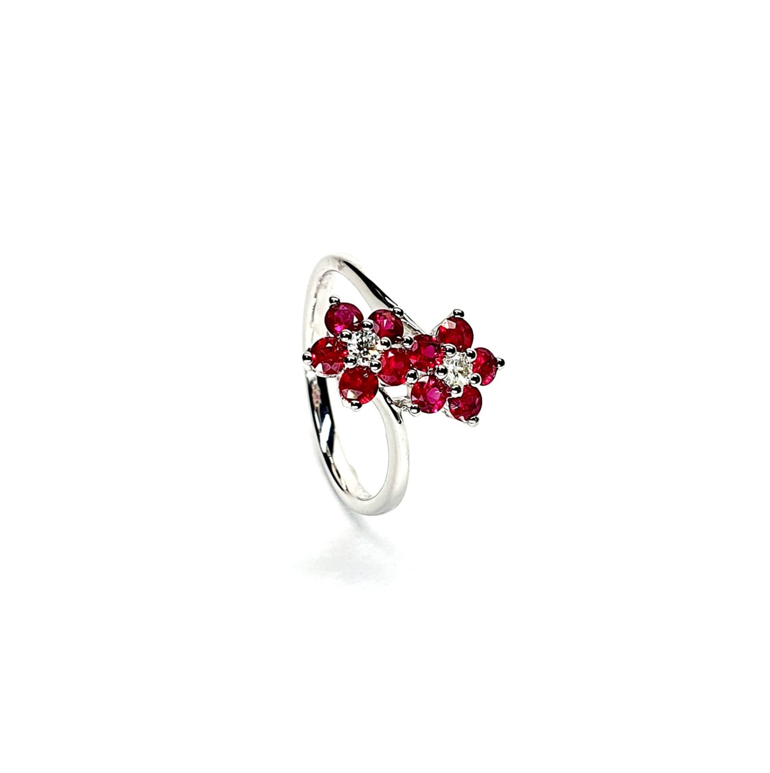 Ruby Double Cluster Ring with claw settings crafted in 18ct white gold featuring two clusters of five round bright red rubies with a single diamond centre to each cluster