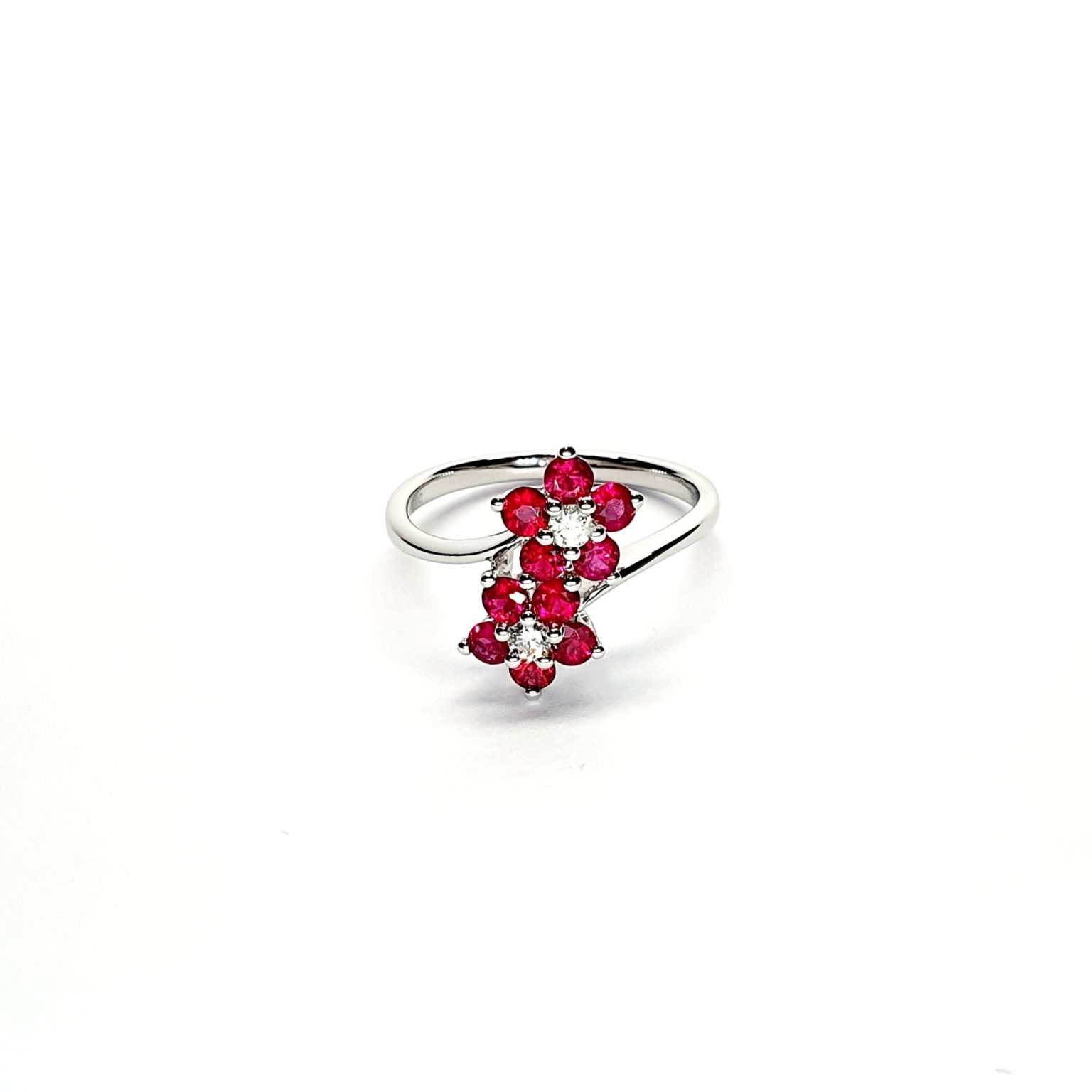 Ruby Double Cluster Ring with claw settings crafted in 18ct white gold featuring two clusters of five round bright red rubies with a single diamond centre to each cluster