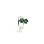 Double Cluster Emerald Ring. Crafted in 18ct white gold featuring two clusters of five round bright green emeralds with a single diamond to the centre of each cluster, with a wave cross over shank