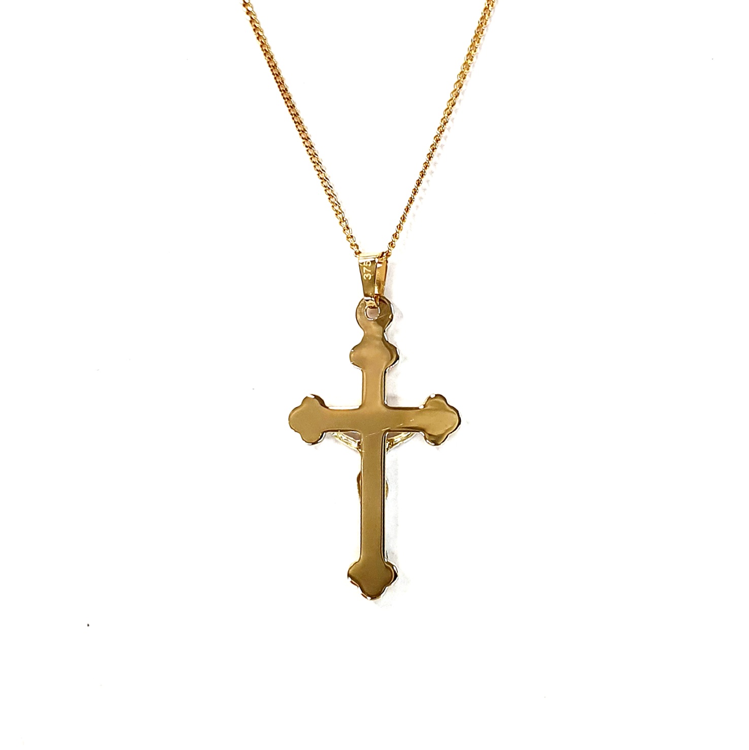 The Staveley 9ct Crucifix Necklace is 32mm with the top saddle loop 25mm x 16.8mm without and is 2mm in depth. It is made with a hollow 9ct yellow gold tube with a white gold Jesus, all highly polished. It can be purchased independently or with a 16, 18 or 20-inch traditional solid gold curb link chain.