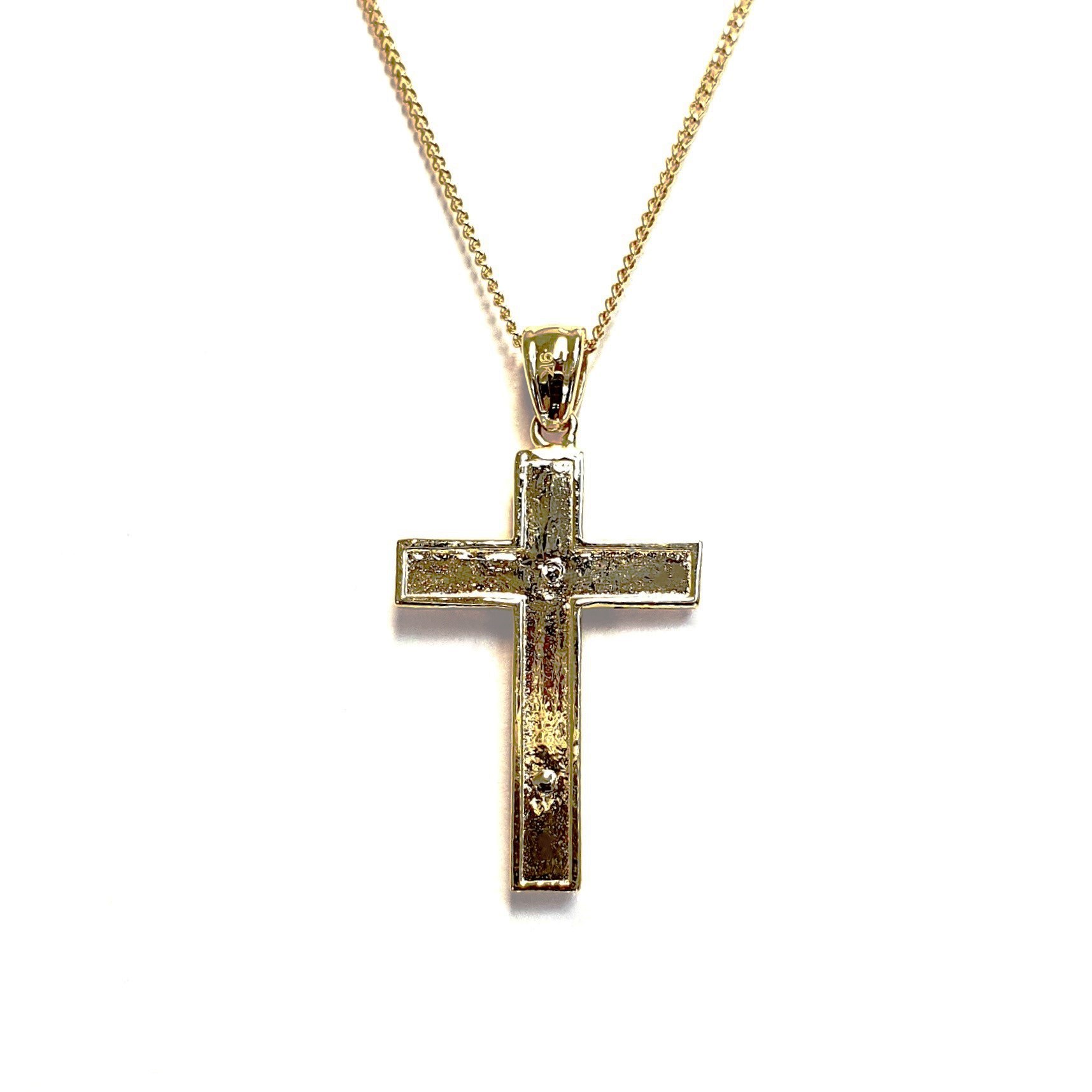 A yellow gold cross with an intricate white gold Jesus & a chris cross matt background with a contrasting sparkling diamond cut patterned edging.