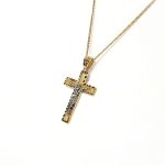 A yellow gold cross with an intricate white gold Jesus & a chris cross matt background with a contrasting sparkling diamond cut patterned edging.