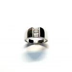 950 Platinum signet style ring set with three baguette diamonds in a landscape rub-over setting, showing at a slight angle to the top