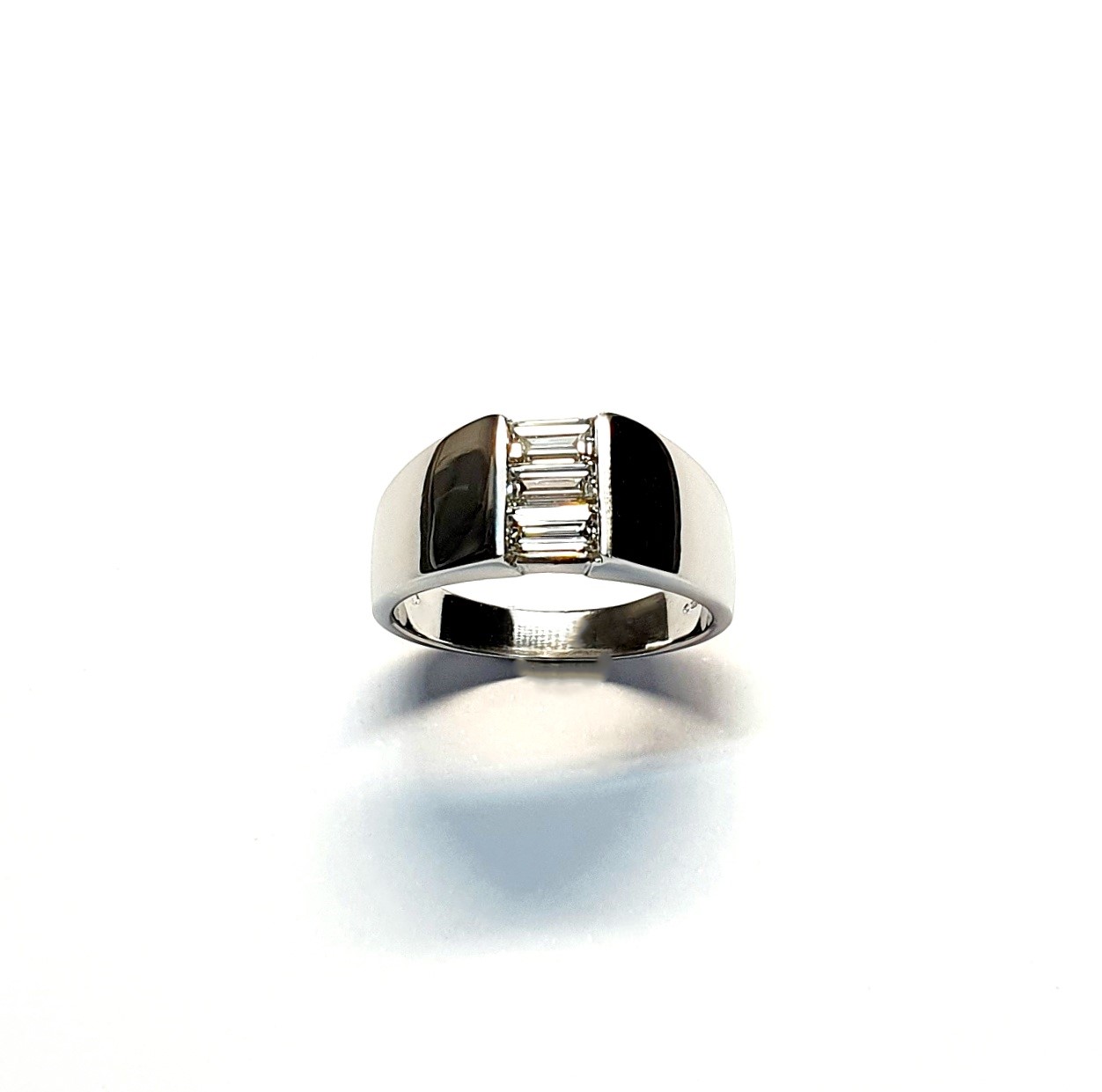 950 Platinum signet style ring set with three baguette diamonds in a landscape rub-over setting, showing at a slight angle to the top