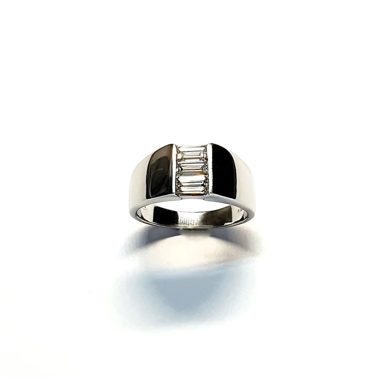 950 Platinum signet style ring set with three baguette diamonds in a landscape rub-over setting, showing at a slight angle to the top