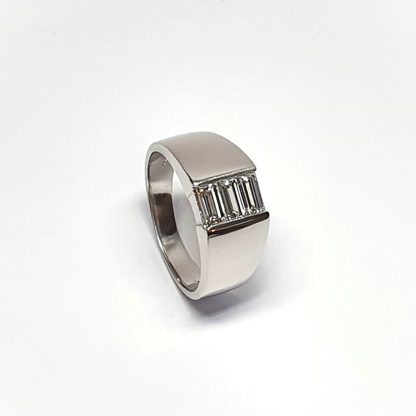 950 Platinum signet style ring set with three baguette diamonds in a landscape rub-over setting, showing at a 45% angle closer look with natural background