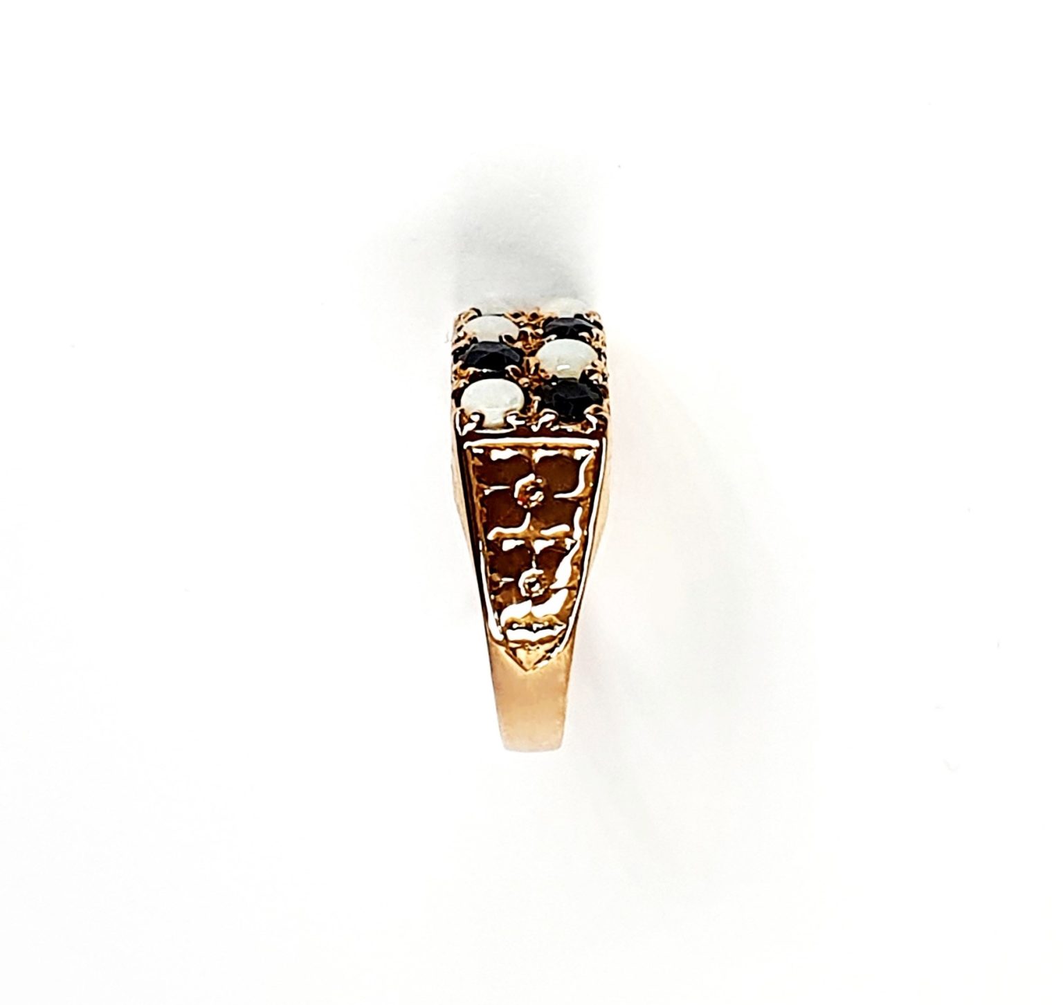 Vintage 1979 opal & dark blue sapphire 9ct gold landscape rectangular top ring measuring 18mm x 7.8mm set with five round cabochon cut opals & five round dark blue sapphires in a chequer formation with three hand engraved flowers to both—side shoulders..