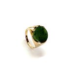 9ct yellow gold round jade abstract Pre-Loved ring measures 16mm x 15mm at the top & 5.8mm high with a single round flat Green Jade stone set on one side with a rub-over setting and a tree bark pattern, and four claws on the opposite side with a plain polished finish