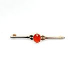 A handmade 9ct yellow gold bar brooch 52mm long set with a gorgeous top quality oval fire opal measuring 8.6mm x 7mm portrait set to the middle of the bar with three 9ct gold diamond shapes to each side of the stone with a straight pin to the back with a swivel safety catch.