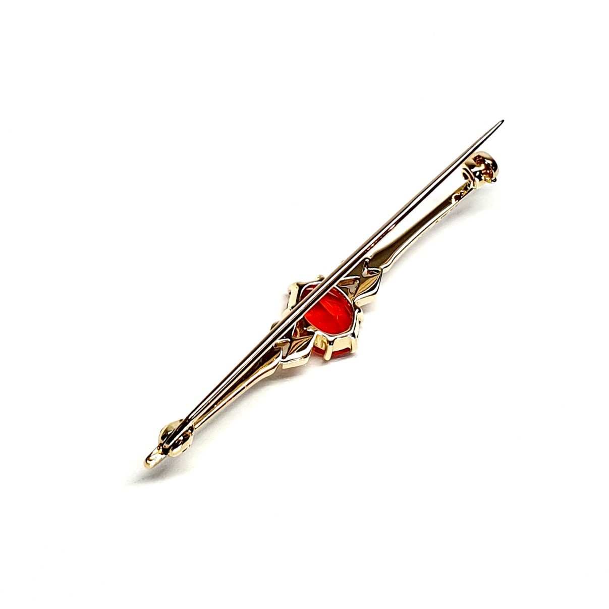 A handmade 9ct yellow gold bar brooch 52mm long set with a gorgeous top quality oval fire opal measuring 8.6mm x 7mm portrait set to the middle of the bar with three 9ct gold diamond shapes to each side of the stone with a straight pin to the back with a swivel safety catch.