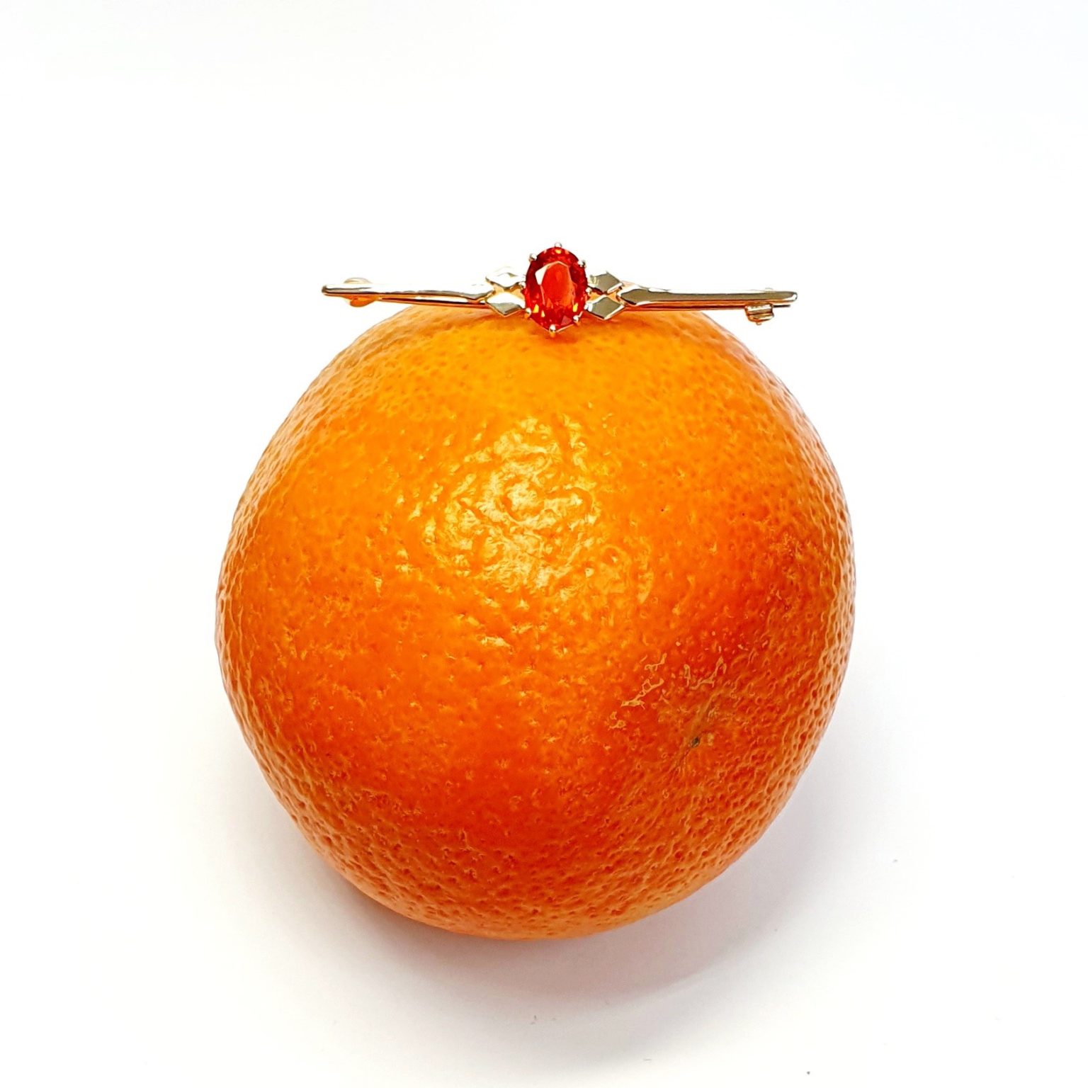 A handmade 9ct yellow gold bar brooch 52mm long set with a gorgeous top quality oval fire opal measuring 8.6mm x 7mm portrait set to the middle of the bar with three 9ct gold diamond shapes to each side of the stone with a straight pin to the back with a swivel safety catch.