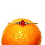 A handmade 9ct yellow gold bar brooch 52mm long set with a gorgeous top quality oval fire opal measuring 8.6mm x 7mm portrait set to the middle of the bar with three 9ct gold diamond shapes to each side of the stone with a straight pin to the back with a swivel safety catch.