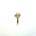 View of the side shoulder of the ring Marquise stones facing left They are crafted in 18ct yellow gold set with a single round 9mm cultured pearl surrounded by fifteen sparkling white round diamonds and two marquise-shaped diamonds with a total diamond weight of 0.31 carats.