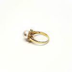 View from the back of the ring laying down top facing left They are crafted in 18ct yellow gold set with a single round 9mm cultured pearl surrounded by fifteen sparkling white round diamonds and two marquise-shaped diamonds with a total diamond weight of 0.31 carats.