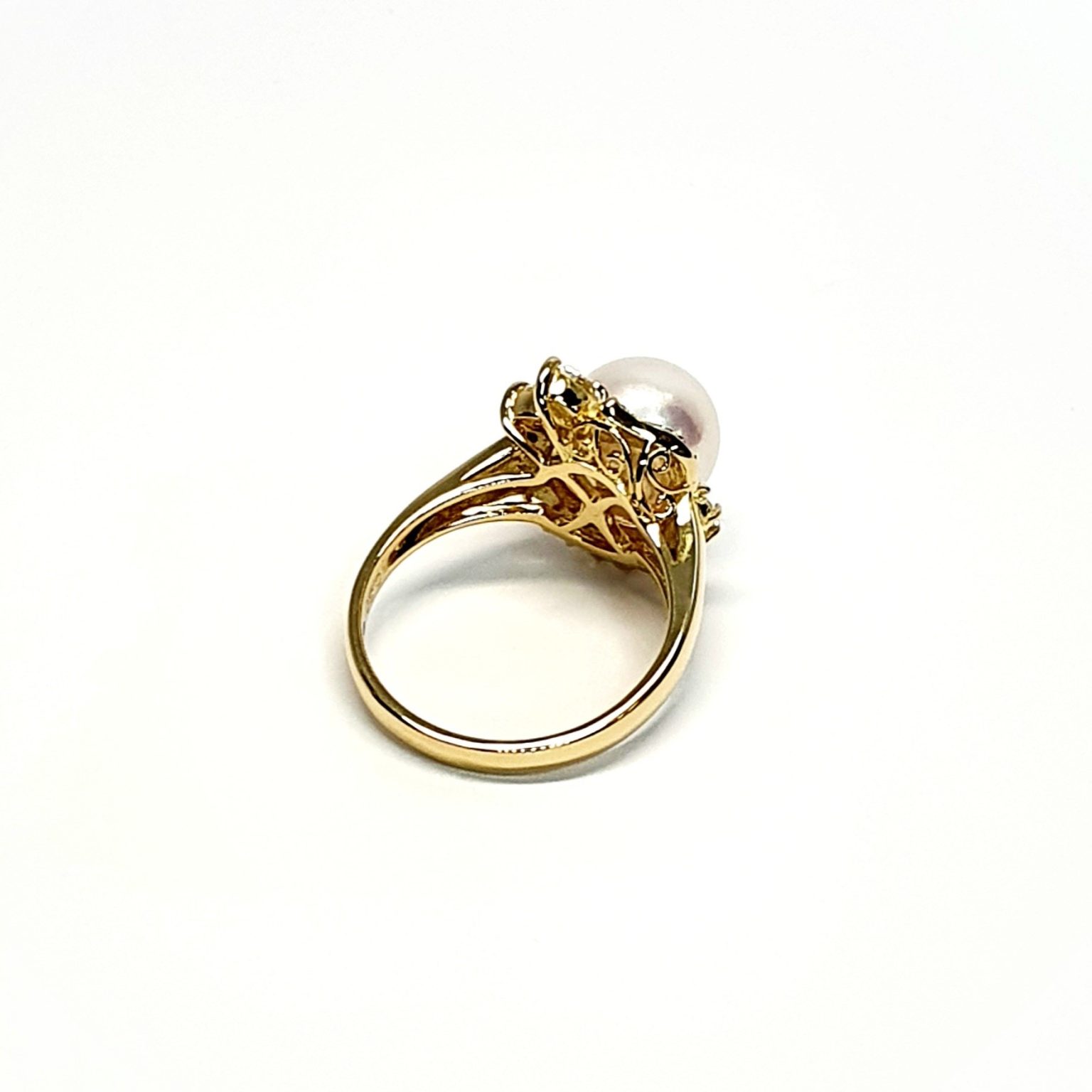 View from the back of the ring laying down top facing right They are crafted in 18ct yellow gold set with a single round 9mm cultured pearl surrounded by fifteen sparkling white round diamonds and two marquise-shaped diamonds with a total diamond weight of 0.31 carats.