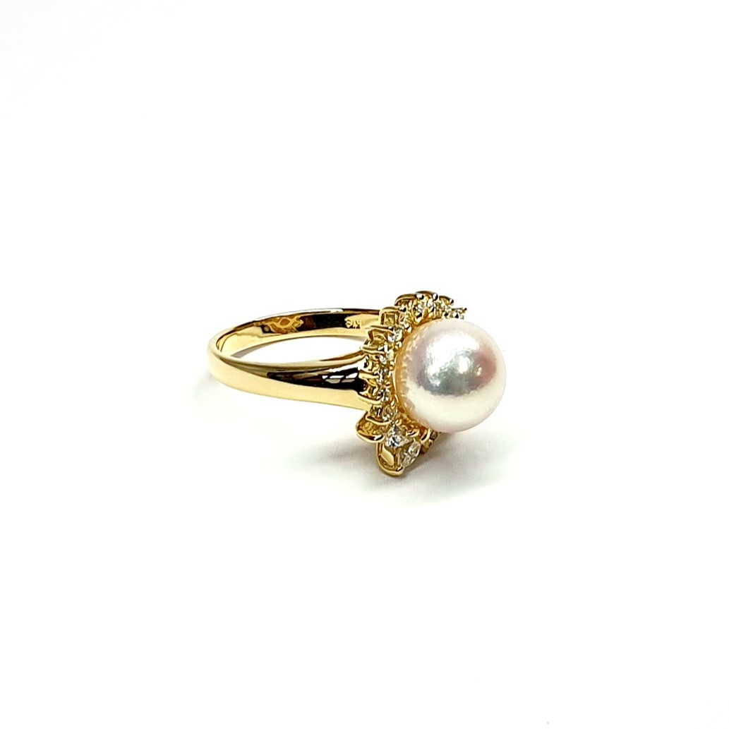 View from the front of ring laying down top facing right They are crafted in 18ct yellow gold set with a single round 9mm cultured pearl surrounded by fifteen sparkling white round diamonds and two marquise-shaped diamonds with a total diamond weight of 0.31 carats.