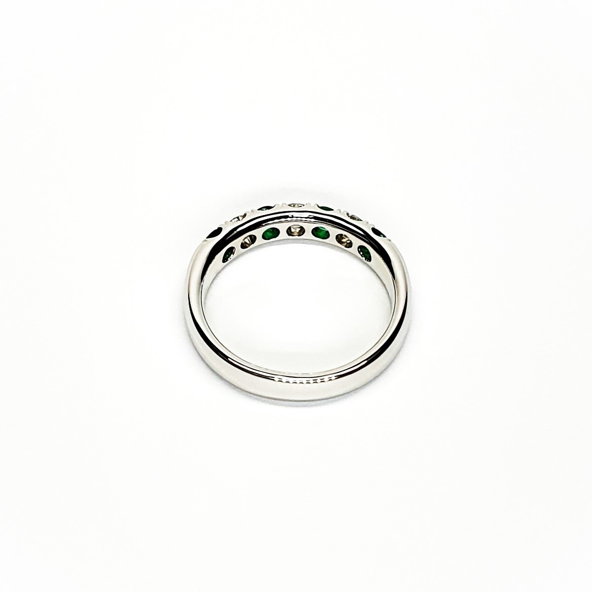18ct White Gold Emerald & Diamond Eternity Ring RA00685 Four 2.8mm round emeralds and three 2.8mm round diamonds ring laying down view of the back.