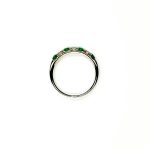 18ct White Gold Emerald & Diamond Eternity Ring RA00685 Four 2.8mm round emeralds and three 2.8mm round diamonds ring laying down side view.