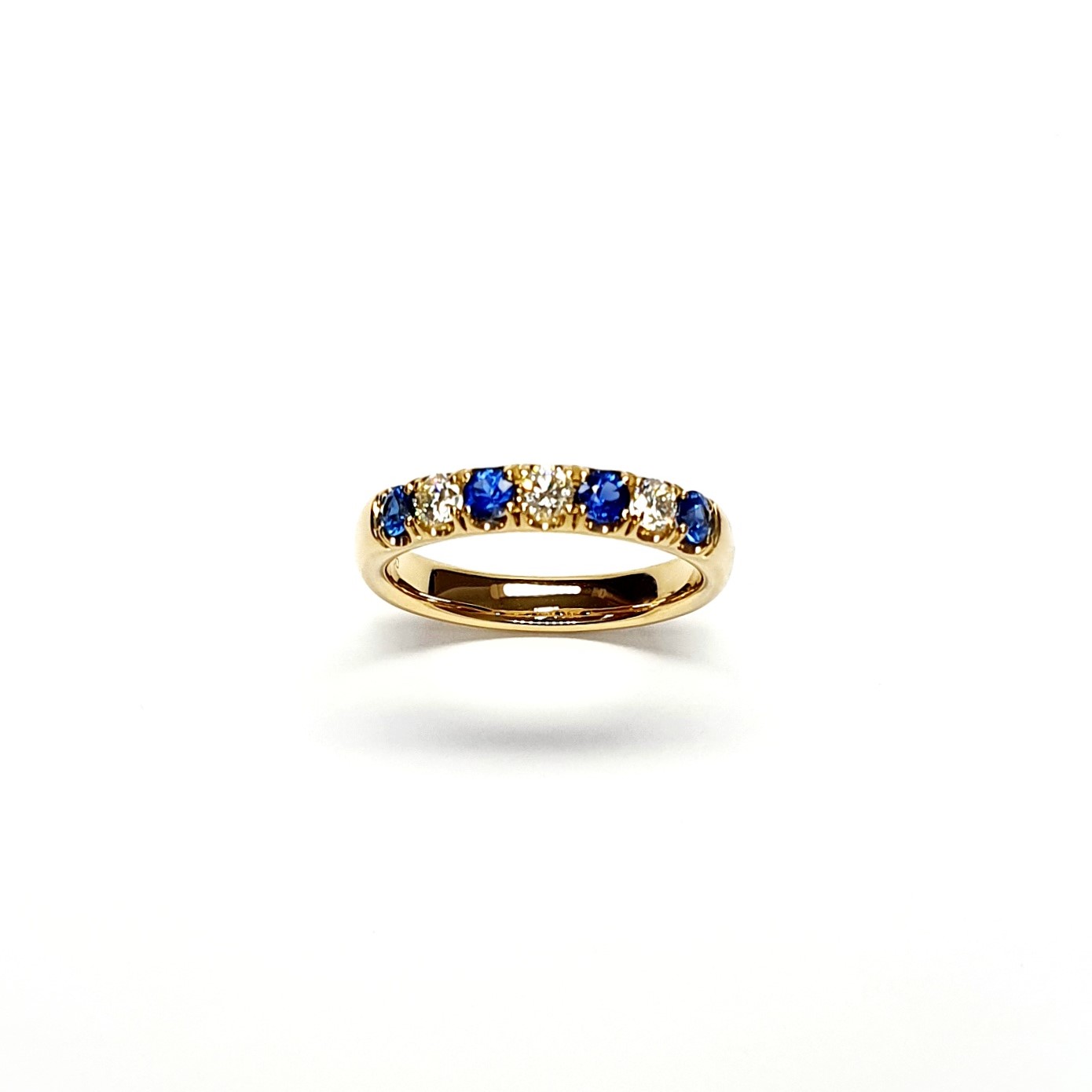18ct Yellow Gold Emerald & Diamond Eternity Ring RA00686 Four 2.8mm round sapphires and three 2.8mm round diamonds ring standing up to the front angled facing to the front.