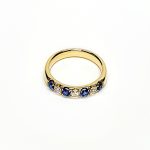 18ct Yellow Gold Sapphire & Diamond Eternity Ring RA00686 Four 2.8mm round sapphires and three 2.8mm round diamonds ring laying down front view.