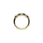 18ct Yellow Gold Sapphire & Diamond Eternity Ring RA00686 Four 2.8mm round sapphires and three 2.8mm round diamonds ring laying down side view.