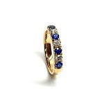 18ct Yellow Gold Blue Sapphire & Diamond Eternity Ring RA00686 Four 2.8mm round sapphires and three 2.8mm round diamonds ring standing up to the front angled facing to the right. Close up with a white background close up